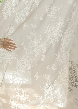 a woman standing in front of a white curtain