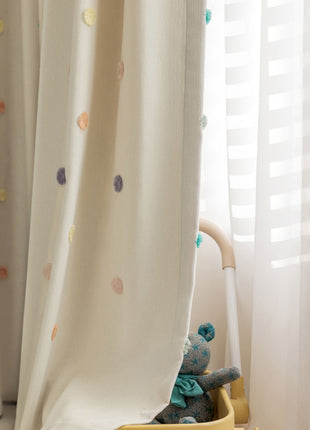 a teddy bear sitting in a toy car in front of a window