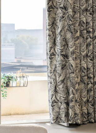 a chair sitting in front of a window next to a window