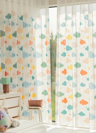 a bedroom with a white bed and a colorful curtain