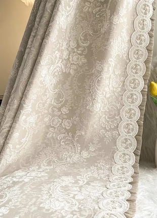 a vase with yellow flowers sitting on a bed