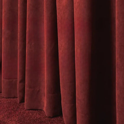 a row of red curtains in a room