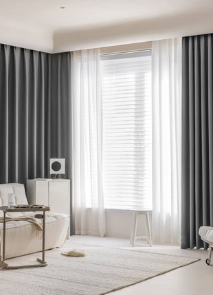 a living room with a white couch and a white chair