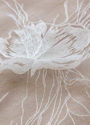 a close up of a flower on a cloth