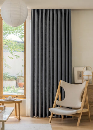 a living room filled with furniture and a large window