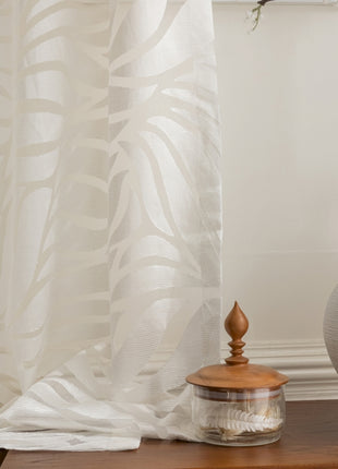 a white vase sitting on top of a wooden table