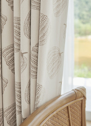 a close up of a chair with a curtain in front of a window