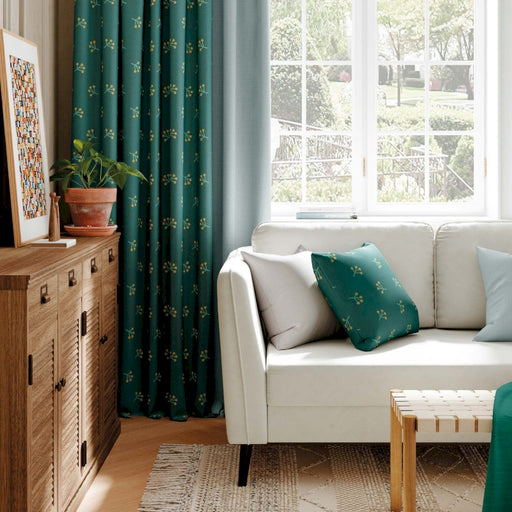 a living room with a white couch and green curtains