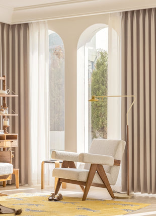 a bedroom with a large window and a chair