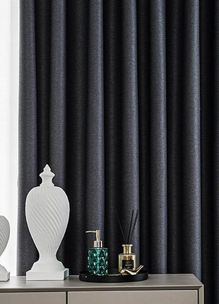 a white vase sitting on top of a dresser next to a window