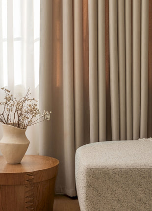 a vase with flowers sitting on a table in front of a window