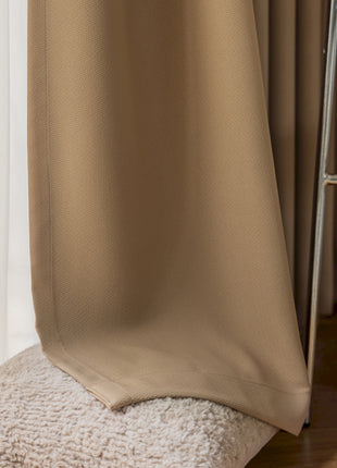 a chair and a curtain in a room