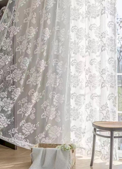 a living room with a chair and a curtain