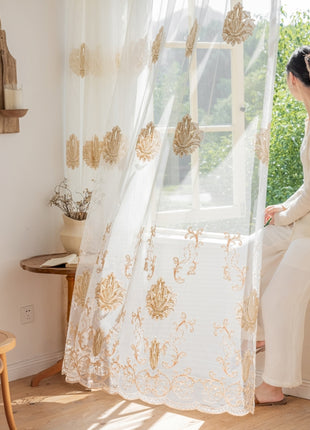 a woman sitting on a window sill looking out the window
