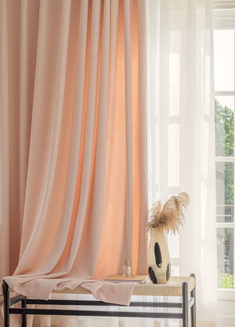 a room with a bed, a window, and a vase