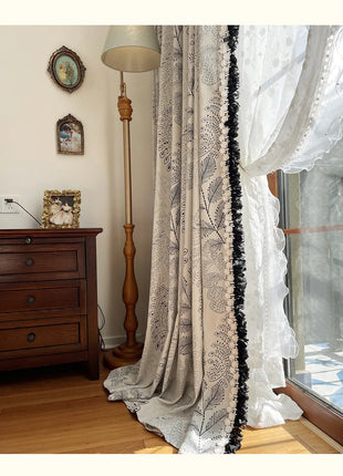 a window with a curtain and a lamp