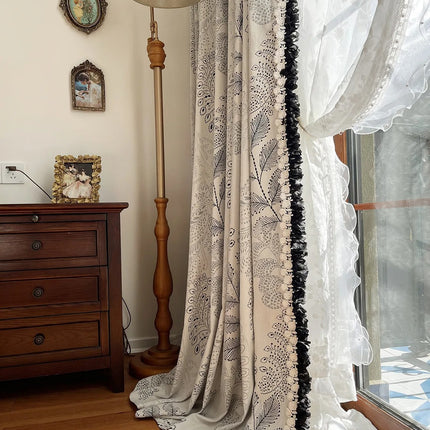 a window with a curtain and a lamp