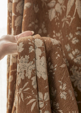 a person's hand holding a curtain in front of a window