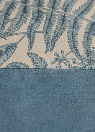 a close up of a blue and white wallpaper with leaves