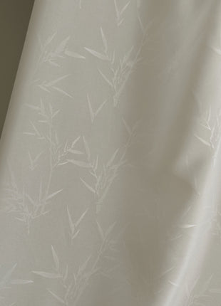 a lamp is next to a white curtain