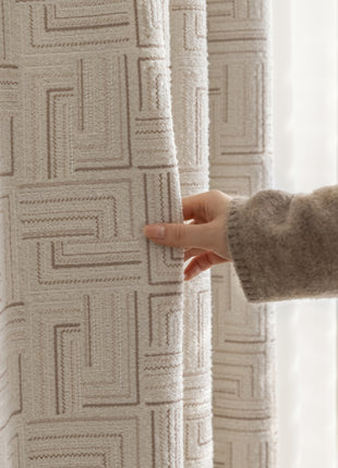 a person holding a curtain with their hand