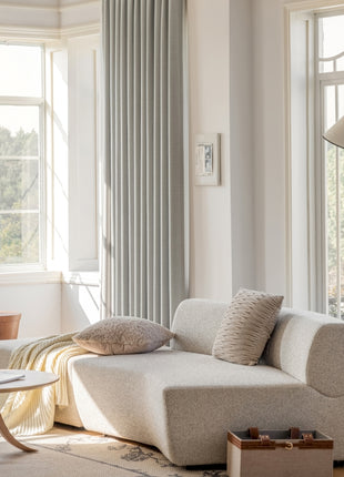a living room filled with furniture and large windows