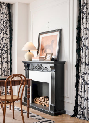 a living room with a fireplace and a table