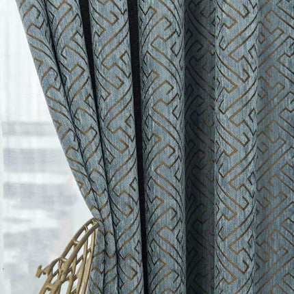 a close up of a curtain with a chair in front of it