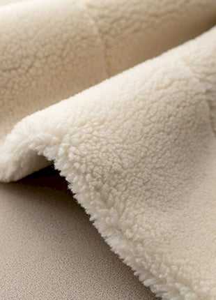 a close up of a white blanket on a bed