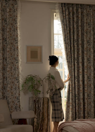 a woman standing in front of a window