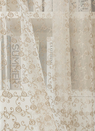 a window with a curtain that has a pattern on it