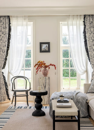 a living room filled with furniture and a large window