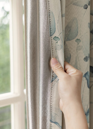 a person is opening the curtains with their hand
