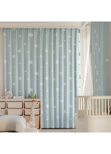 a baby's room with blue curtains and a white crib