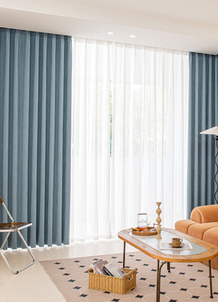 a living room filled with furniture and a large window