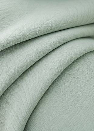 a close up of a light green fabric