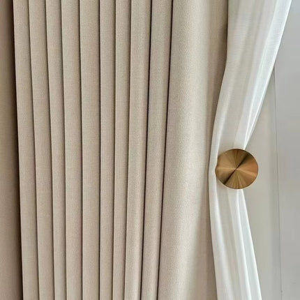 a close up of a curtain with a gold button on it