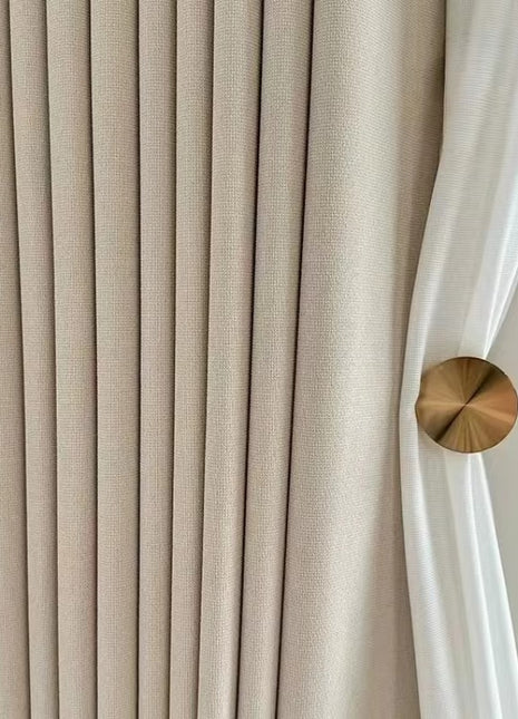 a close up of a curtain with a gold button on it