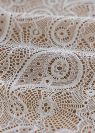 a close up of a white lace fabric