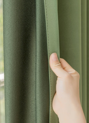 a hand is holding a curtain in front of a window
