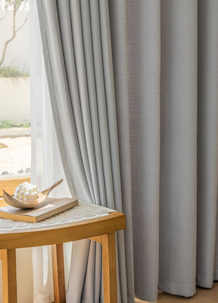 a wooden table sitting next to a window