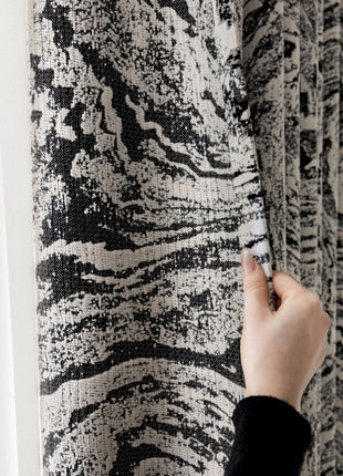 a person is writing on a wall with a pen