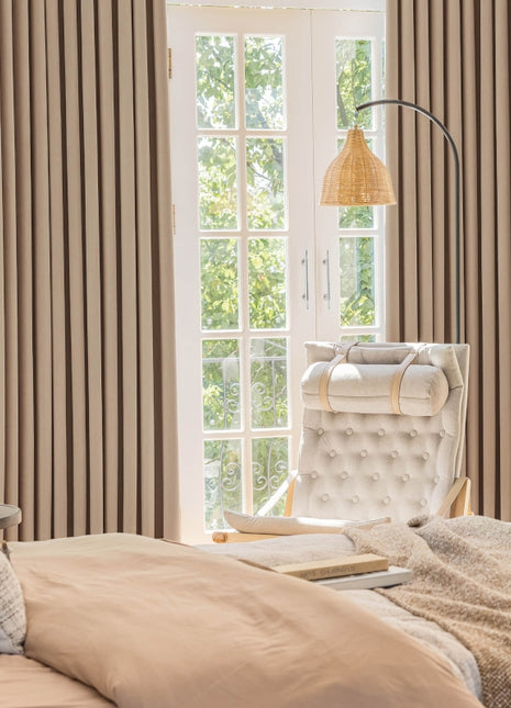 a bedroom with a bed, chair and window