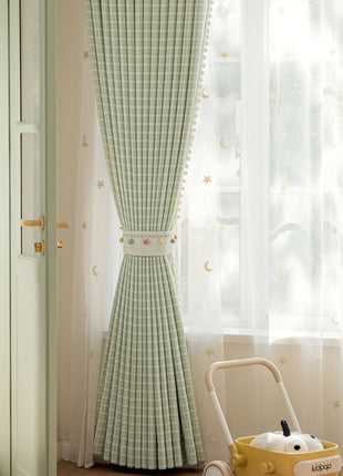 a green and white checkered curtain in a child's room