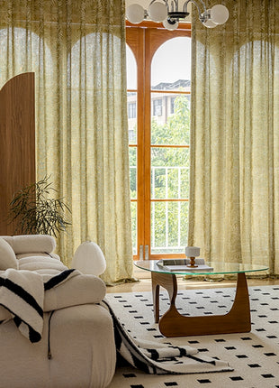 a living room filled with furniture and a large window