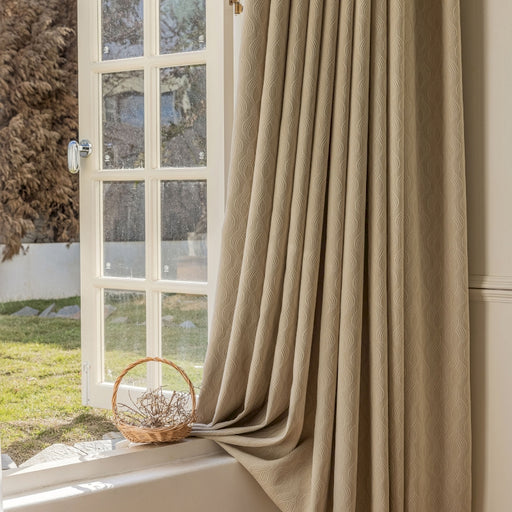 a window with a curtain and a basket on the window sill