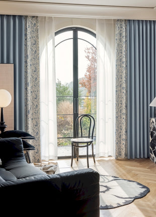a living room filled with furniture and a large window