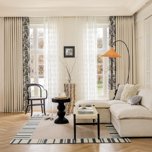 a living room filled with furniture and a lamp