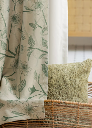 a basket sitting next to a window with a curtain