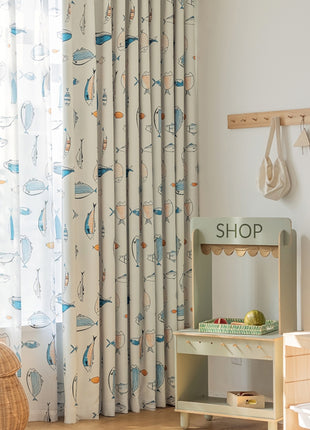a child's room with a wooden table and a curtain